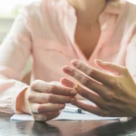 Woman taking off wedding ring